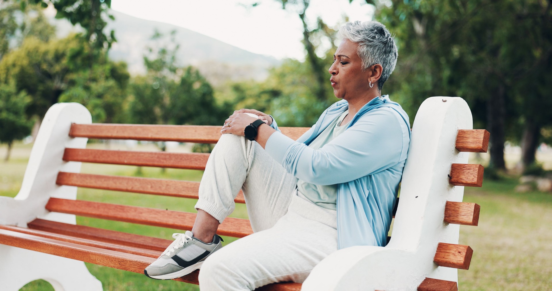 Knee pain, fitness and mature woman in park with injury, muscle strain and inflammation on bench. Nature, sports and senior person with accident for exercise, workout and walking outdoors for health Knee pain, fitness and mature woman in park with injury, muscle strain and inflammation on bench. Nature, sports and senior person with accident for exercise, workout and walking outdoors for health